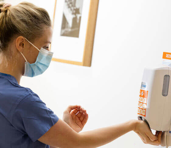 Nurse using hand sanitzer