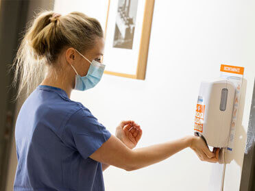 Nurse using hand sanitizer